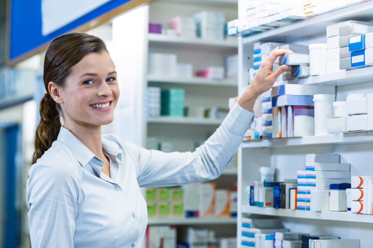 pharmacist-checking-a-medicine-in-pharmacy.jpg