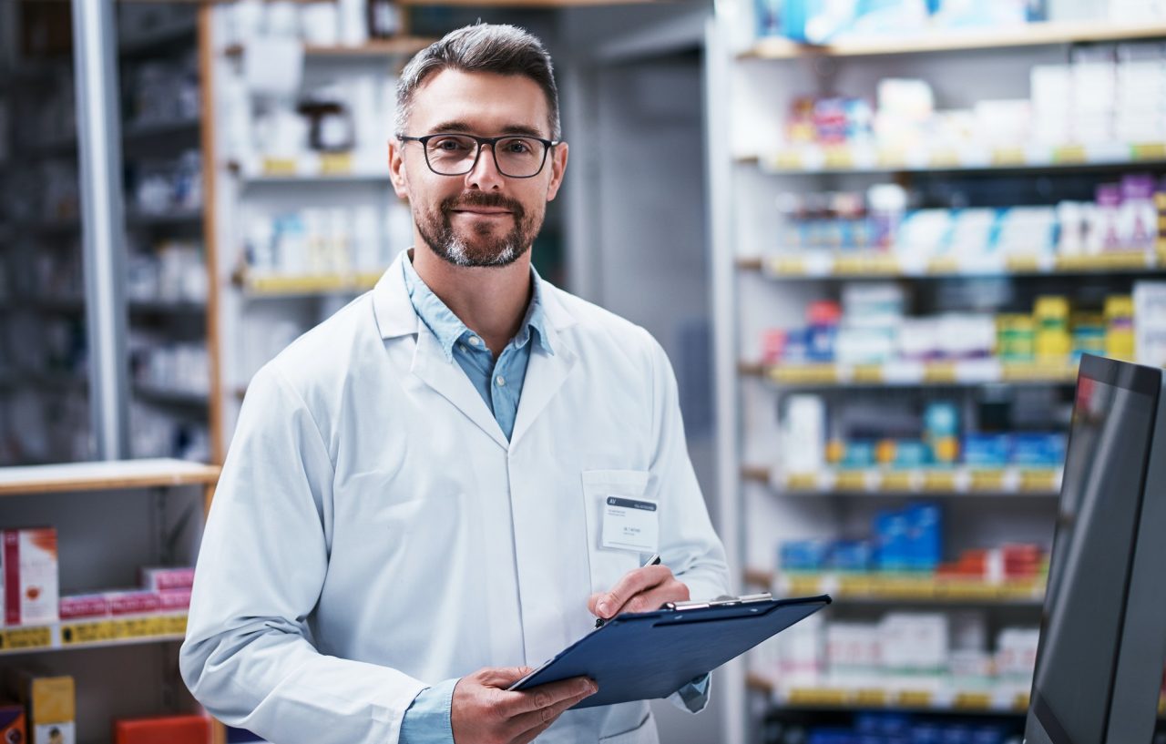 portrait-of-a-mature-pharmacist-writing-on-a-clipboard-in-a-pharmacy.jpg